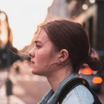 a young woman looking out in cityscape